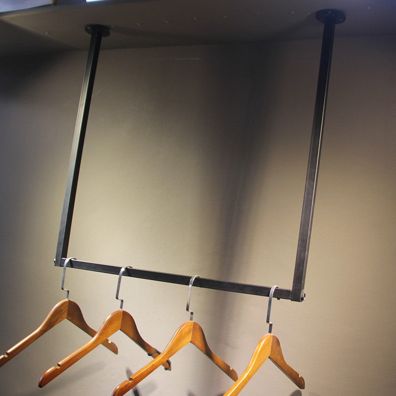 Clothing store shelves on wall hanging hanging hanging hanging hanging clothes hanging dress hanging