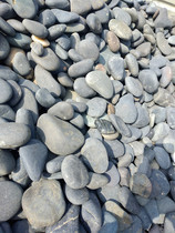 Black unpolished cobblestone Rain flower stone engineering worksite with large stone cyan grey transformer filter oil stone