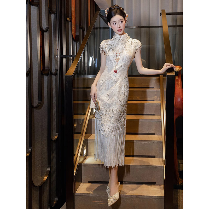 Champagne-colored, modern chinese-style cheongsam with tassel  embellishments  the perfect wedding toast dress for the