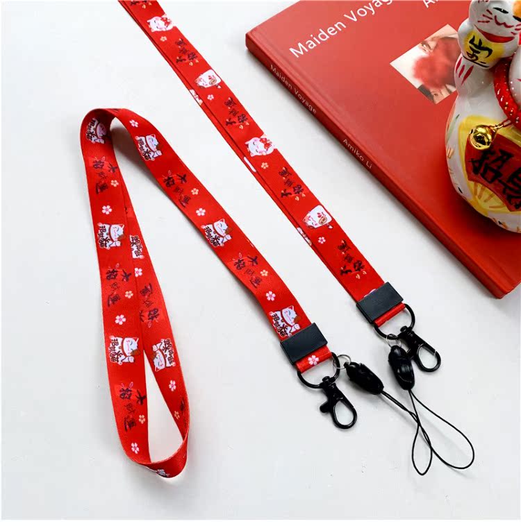 New Year Lucky Cat điện thoại dây buộc dây băng thông rộng nữ sáng tạo chủ chốt mặt dây chuyền chuỗi sling chiều dài phim hoạt hình màu đỏ chống mất - Phụ kiện điện thoại di động ốp lưng samsung j2