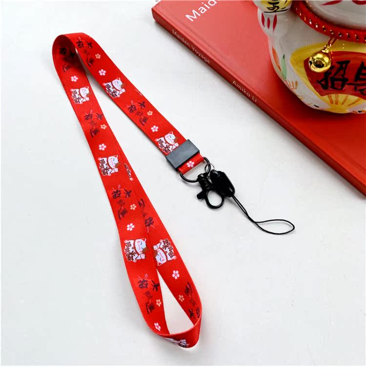 New Year Lucky Cat điện thoại dây buộc dây băng thông rộng nữ sáng tạo chủ chốt mặt dây chuyền chuỗi sling chiều dài phim hoạt hình màu đỏ chống mất - Phụ kiện điện thoại di động ốp lưng samsung j2
