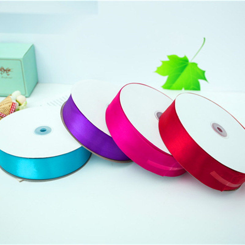 Various color ribbons with Mousse cake surrounded by cake box with cake belt for 100 yards