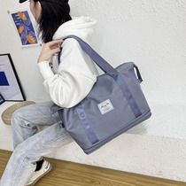 Large-capacity travel bag female portable portable storage bag can be packed quilt long-distance luggage bag man