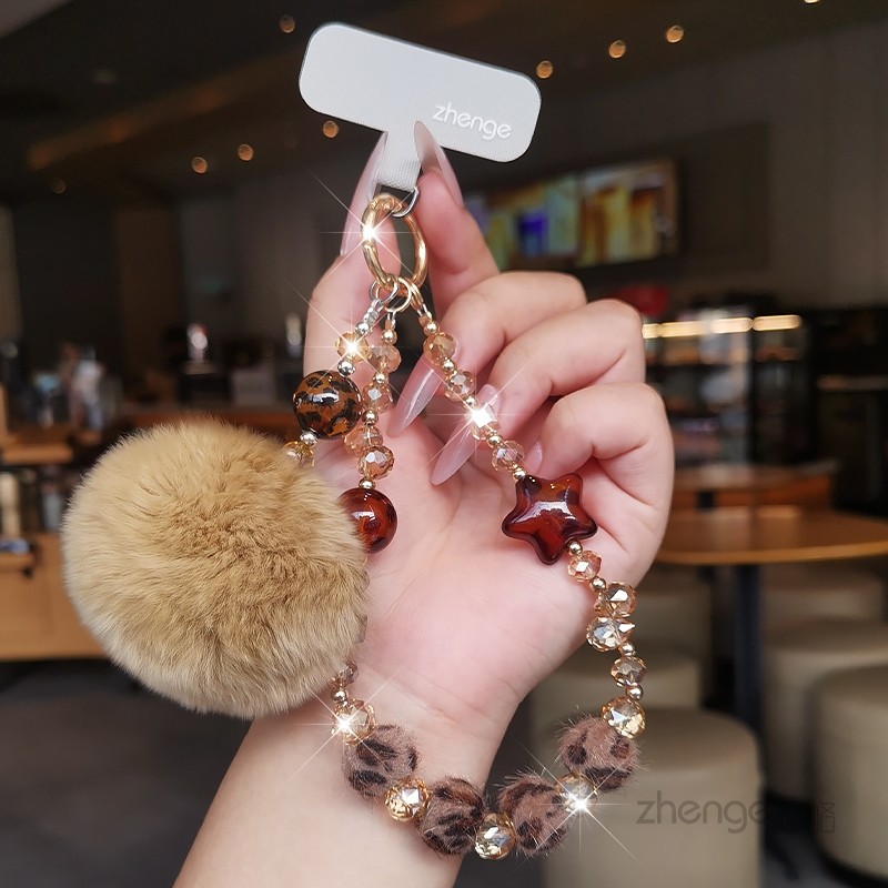 Personalized leopard print plush crystal phone lanyard, high-end pom-pom pendant, outdoor keychain, sturdy.