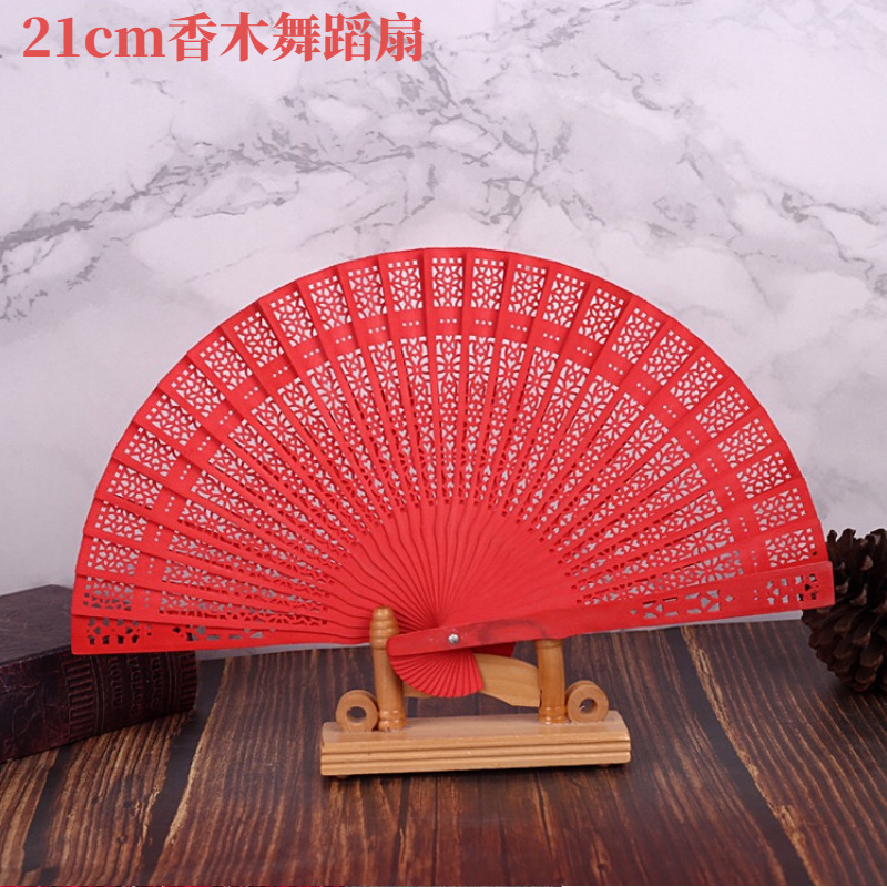 Chinese style solid color red fragrant wood folding fan Hanfu dance hollow fan shooting props to send foreigners small gift fan