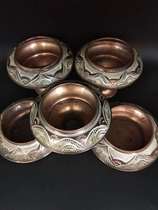 A set of 5 Western European metal bowls 3 of which are hand carved with high feet