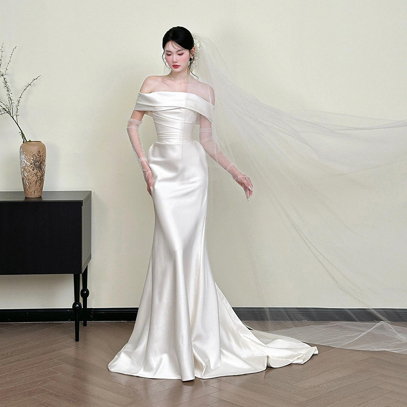 Off-the-shoulder satin wedding dress: a minimalist, woodland-inspired bridal  gown, an ethereal and elegant