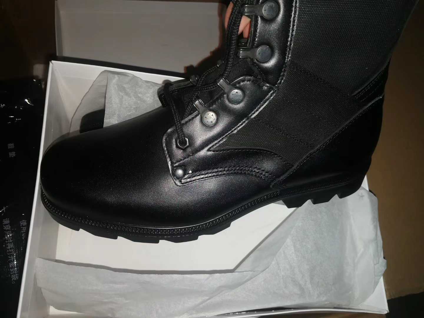 Old models of combat boots on the ground.