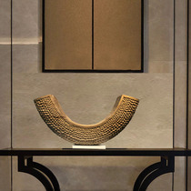 The entrance hall clubhouse is decorated with modern Chinese honeycomb crescent shaped wood color twisted sculpture art ornaments