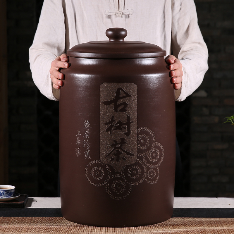 The new Yixing raw mineral purple sand tea jar ancient tree tea carved large Pu'er tea household sealed moisture-proof storage tank