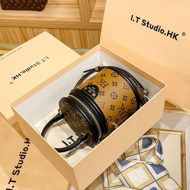 Hong Kong leather bucket bag female 2022 new bag autumn and winter old flower cylindrical messenger hand-held cylinder bag