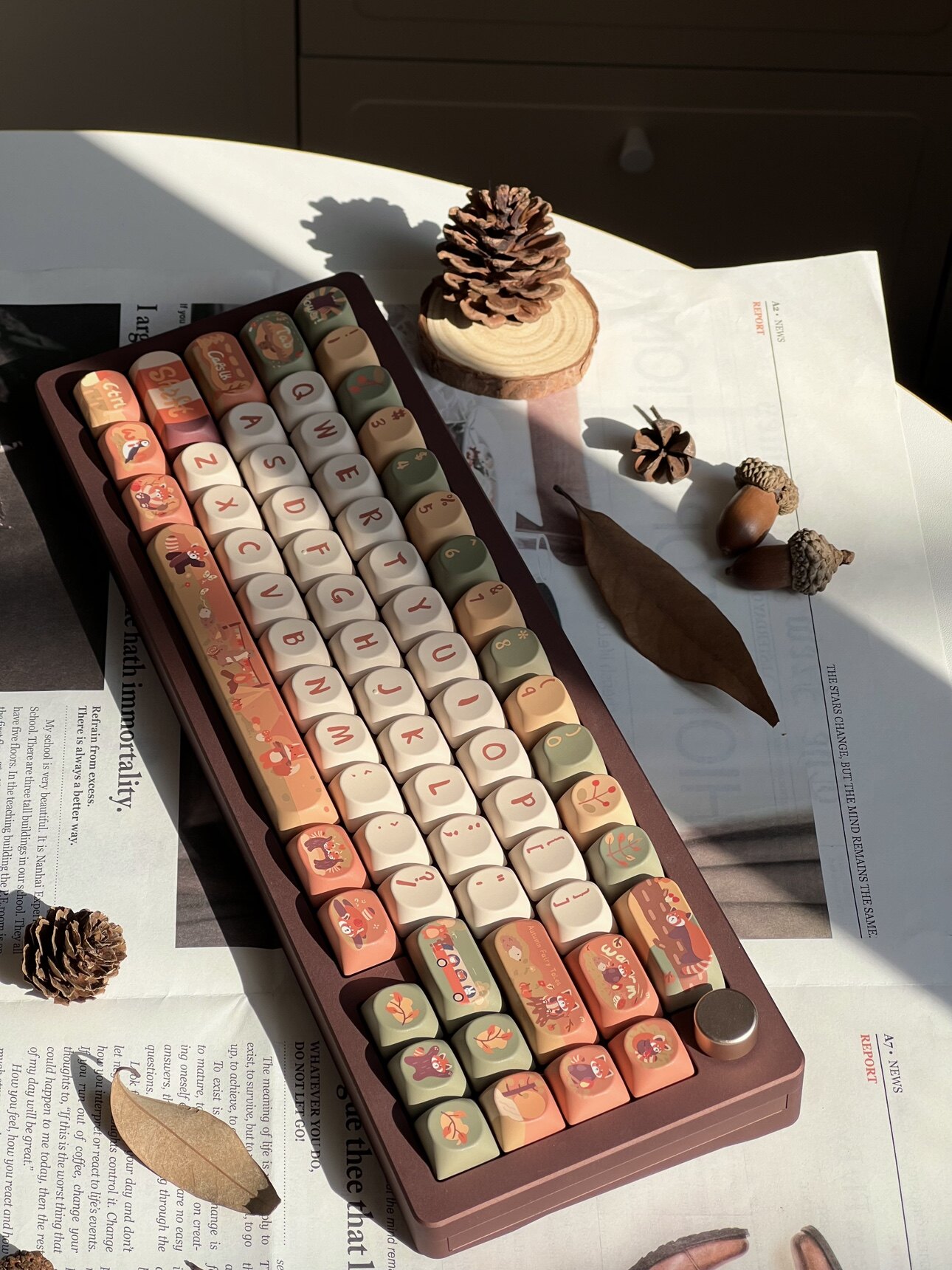 Red Fox and Forest Friends keycap set on a desk with autumn leaves