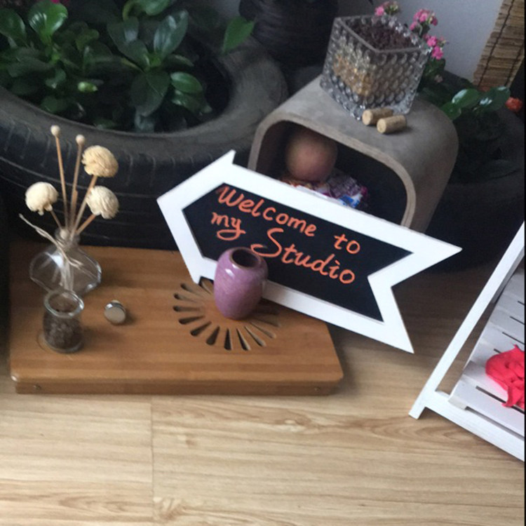 Pastoral style retro old arrow shape bracket small blackboard shop with outdoor guide board pointing road sign