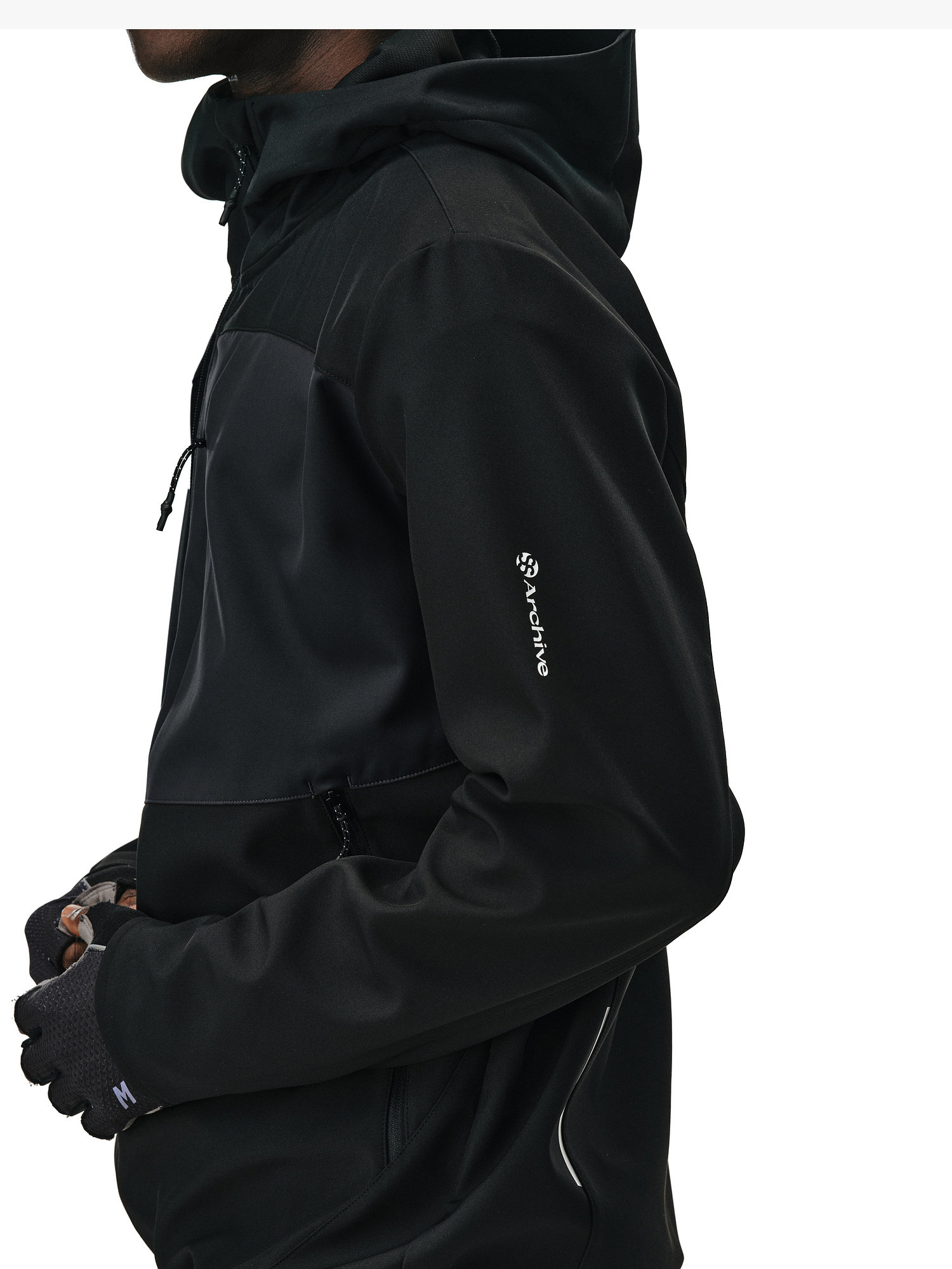 A person in an EastLyst Color-Block Water-Resistant Softshell Jacket and black gloves, photographed from the side against a white background.