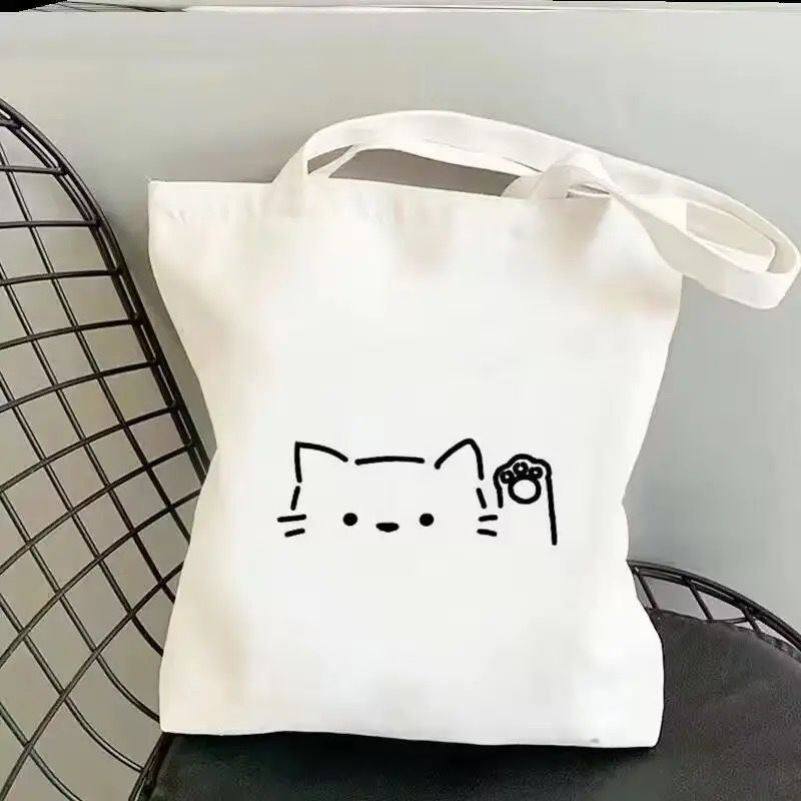 กระเป๋าผ้าแคนวาสสไตล์น่ารักเรียบง่ายสำหรับนักเรียน พิมพ์ลายการ์ตูนแมว แบบสะพายไหล่เดียว เป็นมิตรต่อสิ่งแวดล้อม ความจุใหญ่ มีคุณค่าด้านความงามสูง ใช้งานได้หลากหลาย