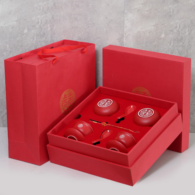 The newlyweds have a pair of teacups and bowls. Wedding toasting teacup suits.