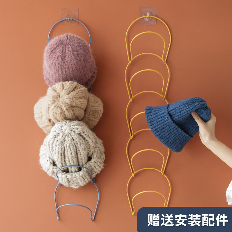 Hanging a hat to receive a frame to hang a hook the wall after door of household to receive artifact to hang a frame to put a cap to buy content frame to hold