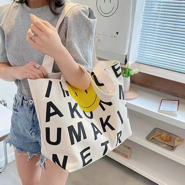 Japanese smiley face mommy bag 2022 new portable one-shoulder canvas large-capacity out-going lightweight tote bag mother and baby bag