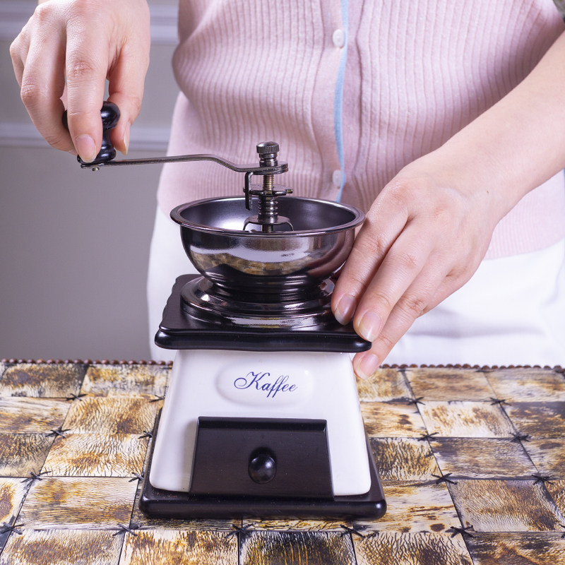 Retro manual hand coffee grinder Coffee grinder Household small ceramic cast iron ornaments prop grinder