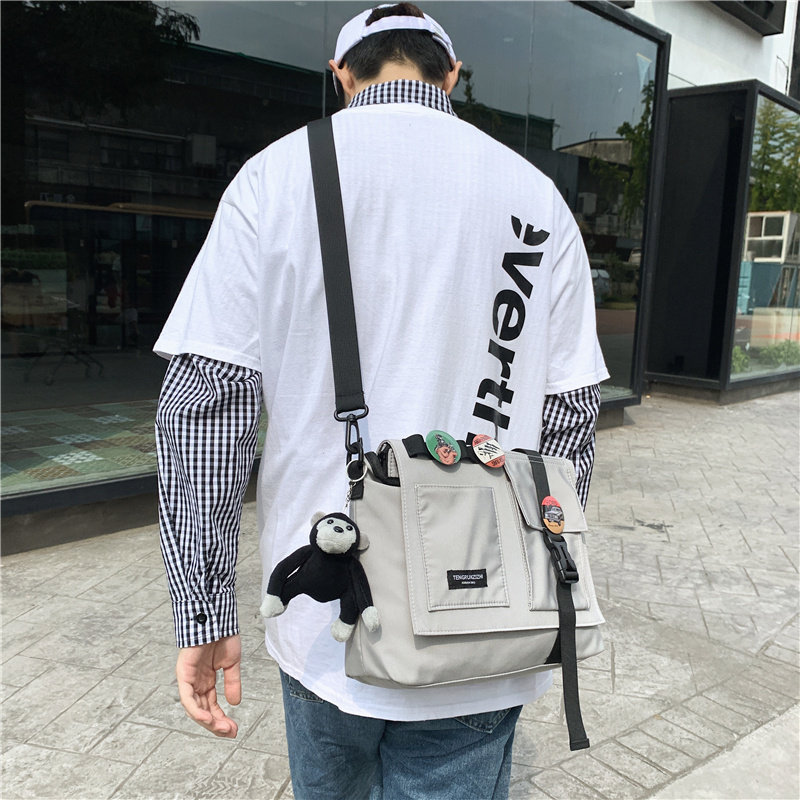 Pendant male messenger bag function messenger bag doll backpack Japanese student tide IPAD bag solid color shoulder bag school bag