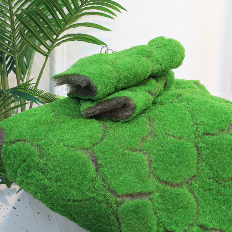 Large cracks-like simulation of green moss artificial lawn plant wall with a view shop window matching display pretending to be decorated