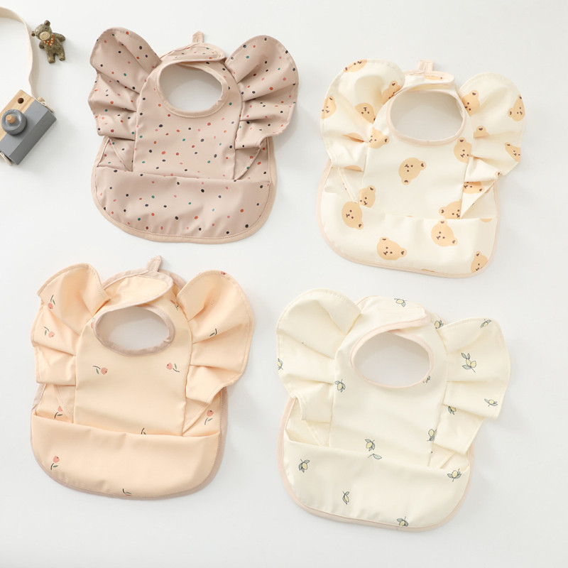 Denmark's new baby food eating round pocket Angels wing bib PU waterproof baby bib to step up the feeding pocket