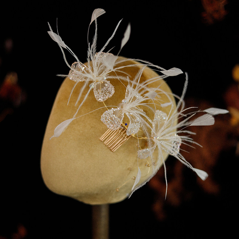 I love seeing handmade white rhinestone petal and feather hair combs for brides, weddings, and vintage-style wedding dresses and accessories.