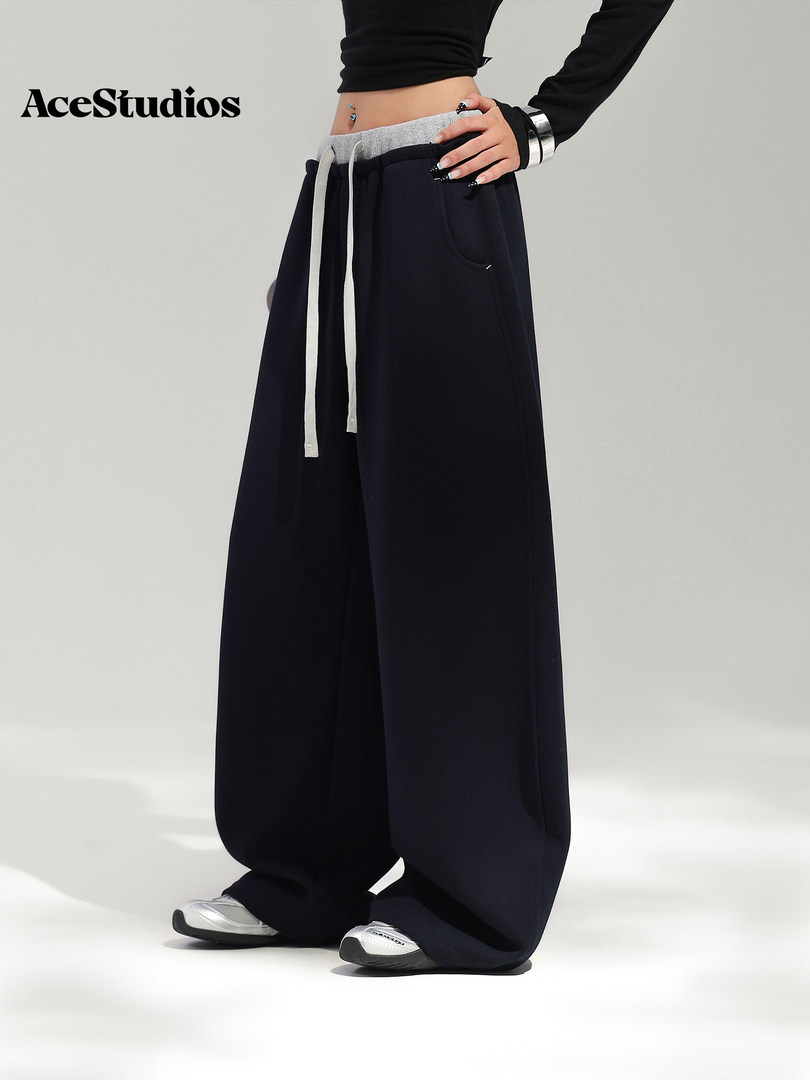 Model wearing black wide-leg drawstring pants with sneakers
