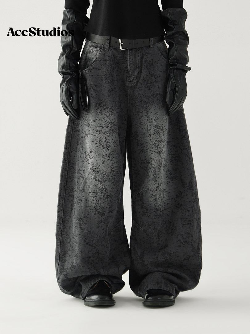 Model wearing black textured wide-leg pants with a gothic streetwear aesthetic.