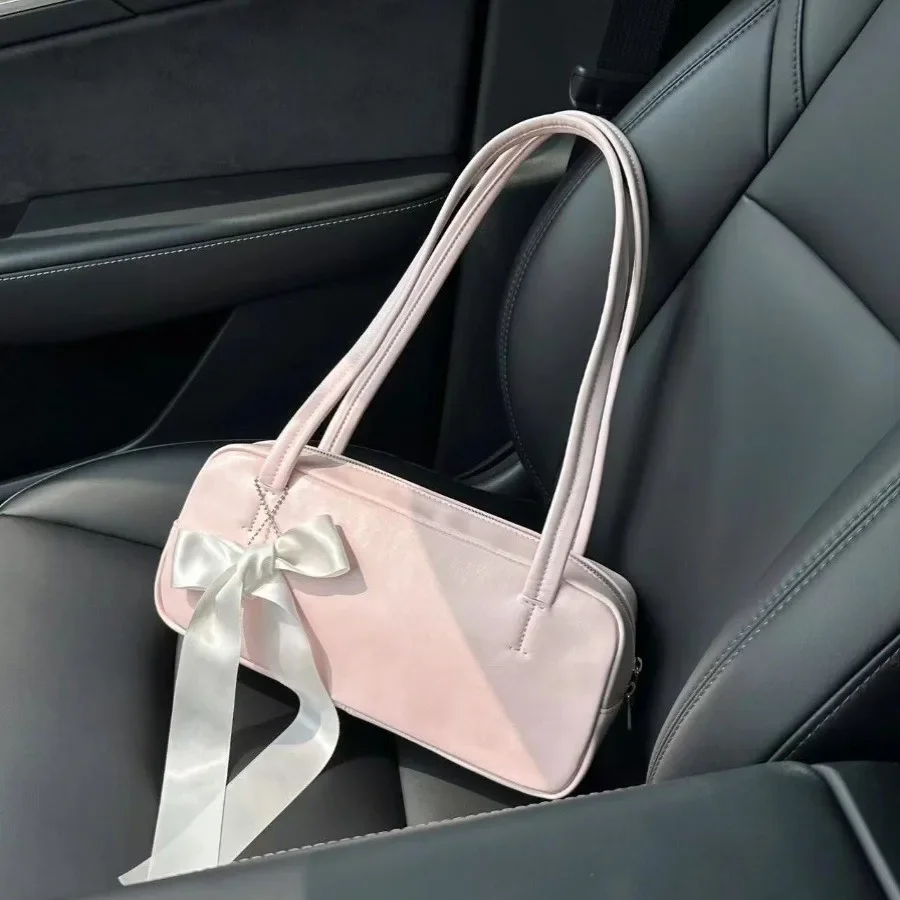 Fashion bow shoulder bag with underarm design, new spring and summer leisure versatile pillow bag, high-end light pink baguette bag