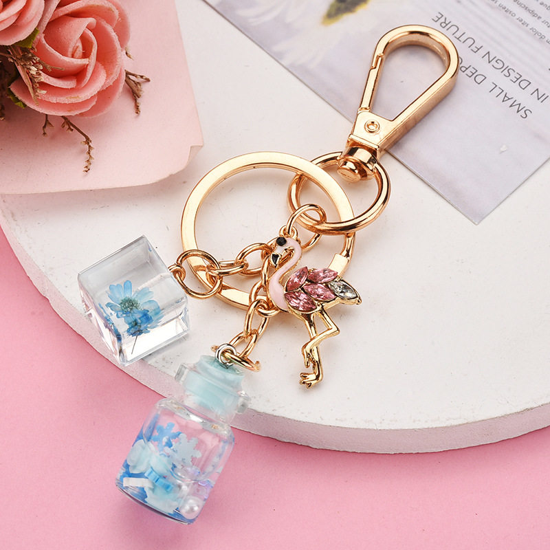 Korean version of the car keychain girl student cute small square bottle flamingo quicksand bottle electric car bag pendant