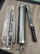 Yellow oil gun with rust on the back of the