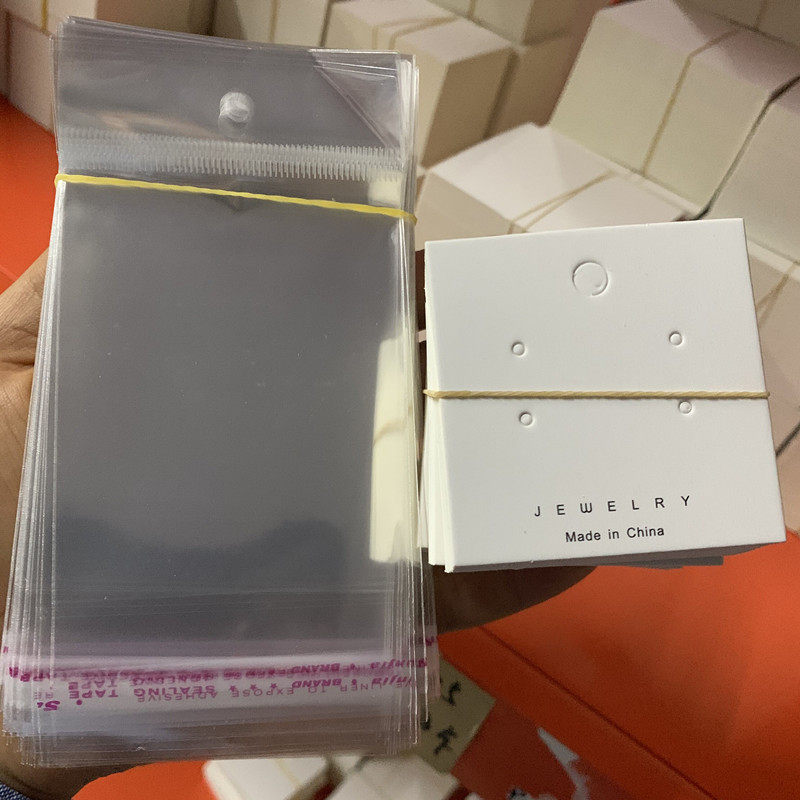 KP204 about 100 sheets of 5 5*5 5 four-hole ear pin cardboard plus a 7*14 about 200 sheets of transparent bag