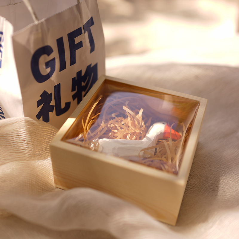 The wood small gift box does not contain a big white goose and a box containing more than one 