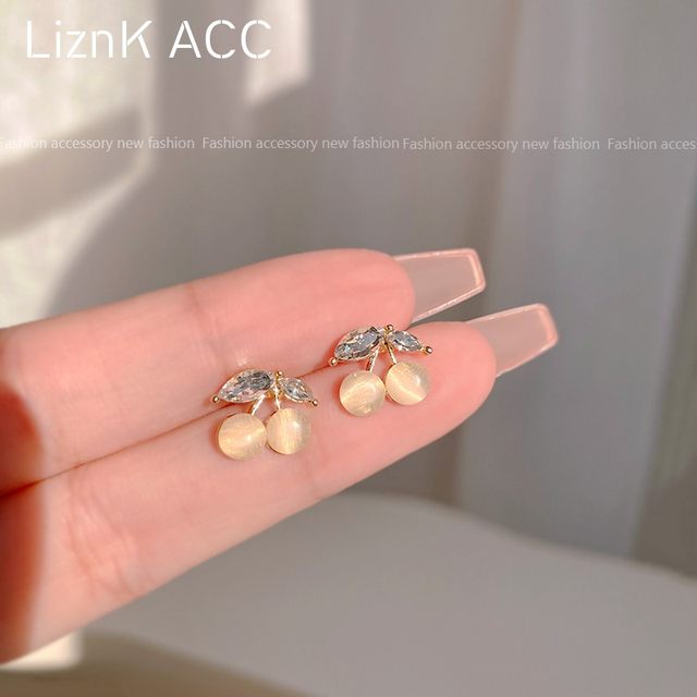 s925 silver needle small cherry cat's eye earrings women fairy beauty spring and autumn small earrings 2023 ແນວໂນ້ມໃຫມ່
