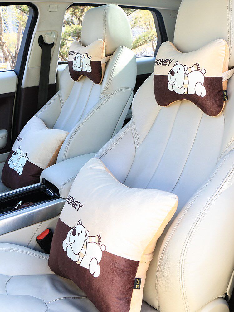 Car with headrest on-board neck pillow in car Cute Little Sedan Dolly in a pillow car leaning against a pillow pair of pillows