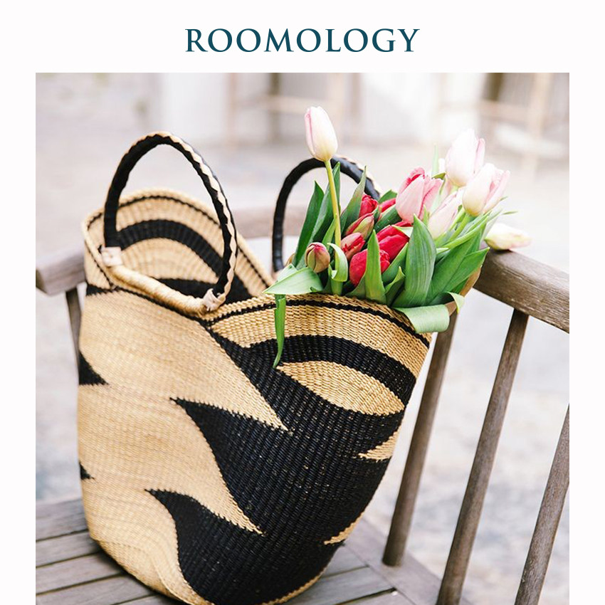 Roomology Africa imports Ghana handmade woven straw woven hand shopping basket containing water fruit basket