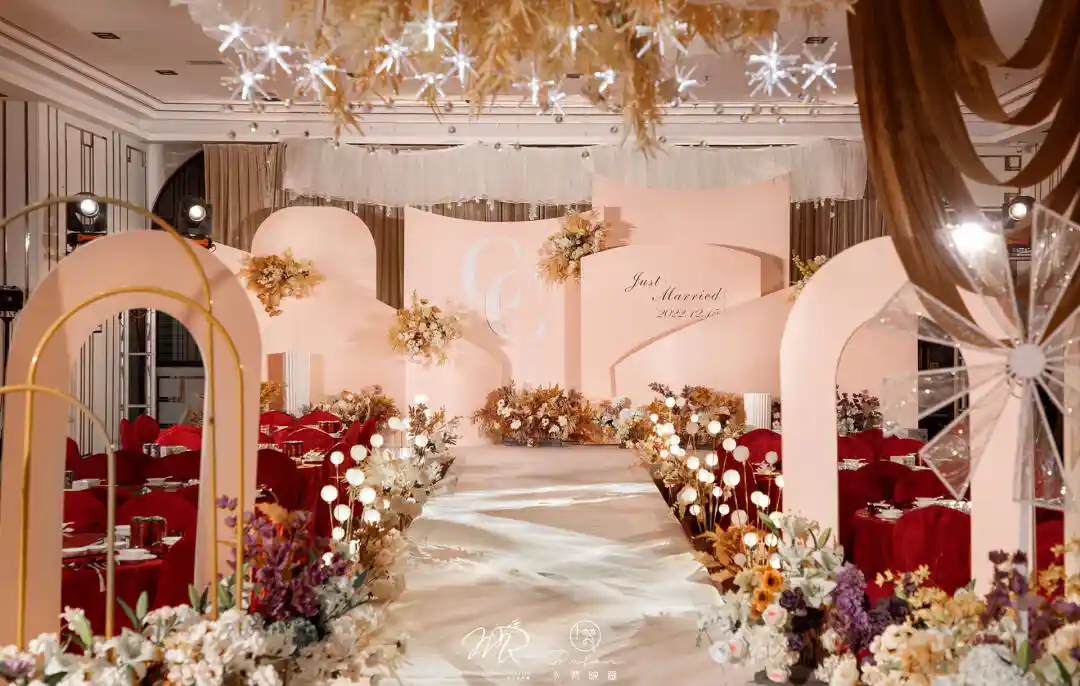 Wedding table styled in blush, champagne, and soft gold with candles and delicate floral arrangements