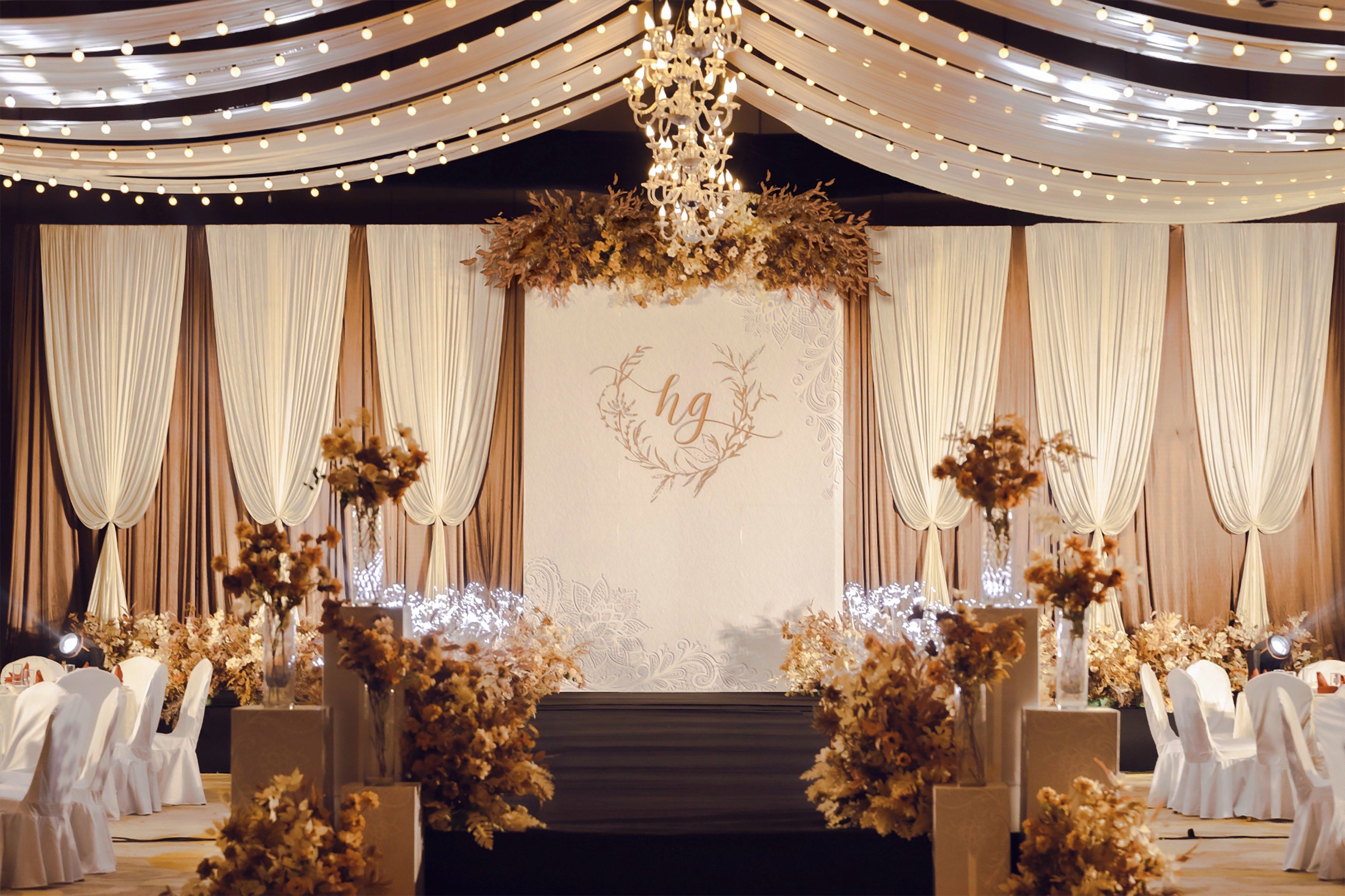 Boho wedding setup with terracotta, rust, and cream colors in flowers, pottery, and textiles