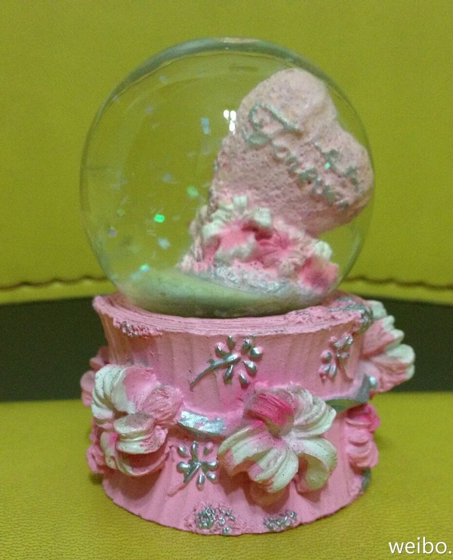 Pink little crystal ball with a little water.