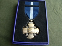 A set of metal badges the NAVY Cross of the United States High Sea Medal