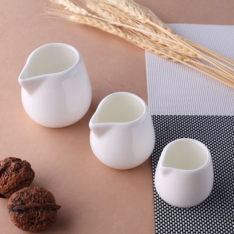 A small coffee milk cup with a small milk spoon Western milk cup cup Western cup milk pot