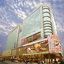 The standard large bed of the Golden Dragon Hotel in Macau