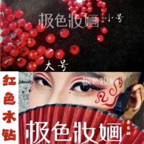 Extreme stage makeup with red rhinestones shiny face with decorative round stones