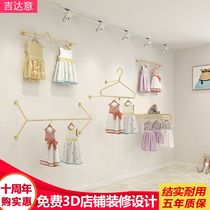 Clothing store childrens clothing store display shelf shelf in the island shelf womens clothing on the wall is hanging on the wall of the golden shop hanging rail