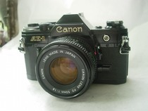 The newer Canon is a rare black AE-1 camera