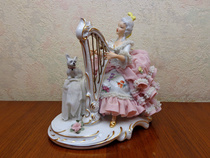 Lady 1950s-1960s who has booked a German Dresden lace porcelain occasional harp.