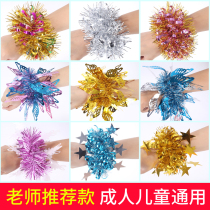 Kindergarten children dance with wrist flowers. The cheerleading team performs rubber band wrist flowers for the Childrens Day Sports Festival.