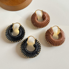 Unique European and American niche earrings, retro pure handmade woven cowhide rope, light luxury, high texture, exaggerated circular earrings for women