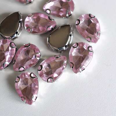 A 15mmx10mm pink teardrop-shaped multi-faceted cut acrylic diamond bead from German JIM